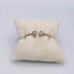 The Pandora Signature Sterling Silver Open Bangle is a stylish and elegant piece